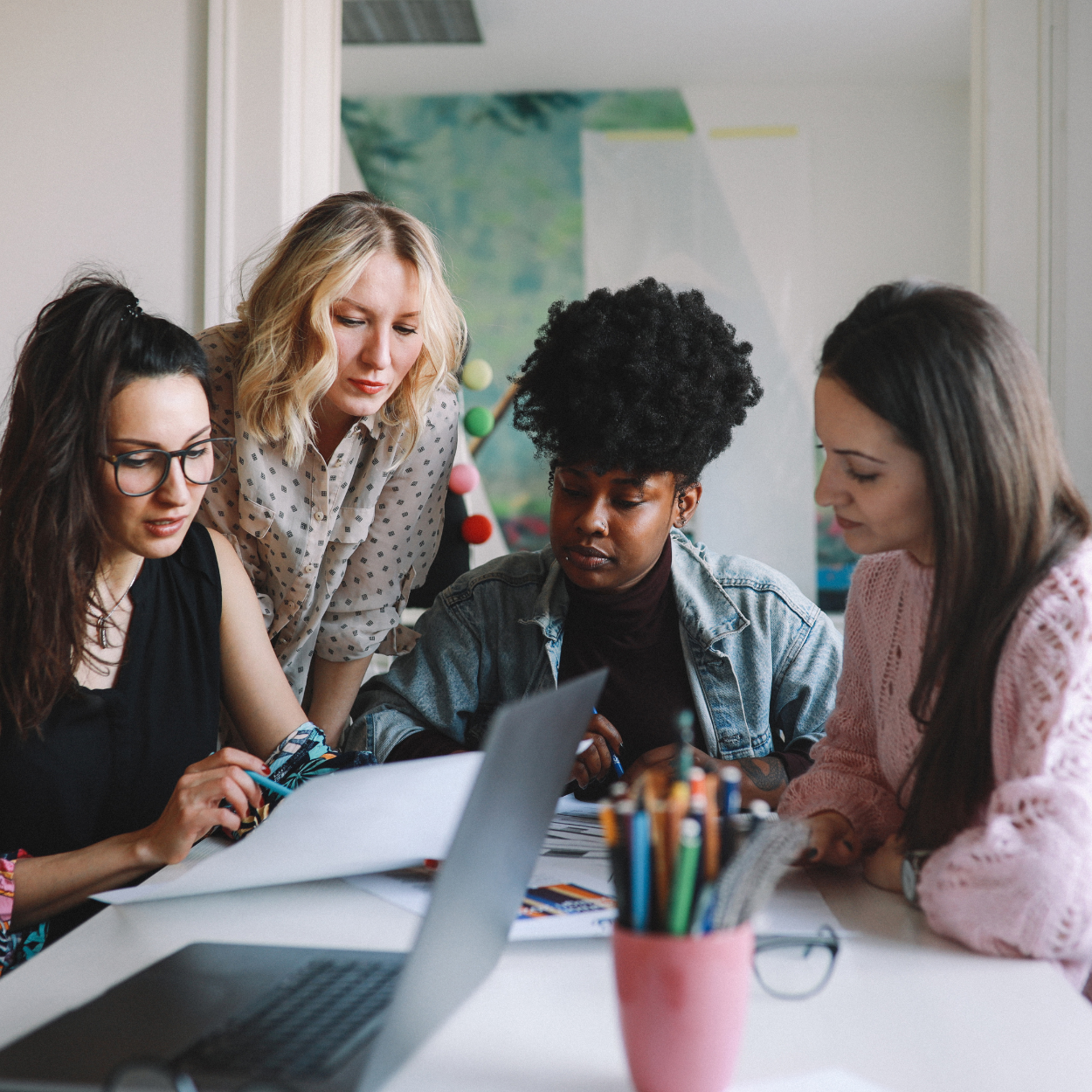 4 women working around a table