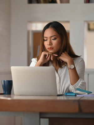 woman thinking while at laptop woman thinking while at laptop